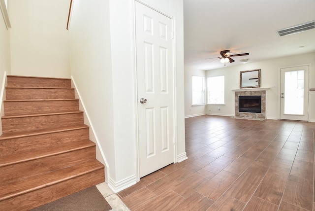 4026 Almond Lake Dr, Houston, TX 77047 - stairway featuring a ceiling fan, baseboards, a fireplace, and wood finished floors