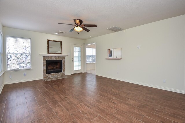 4026 Almond Lake Dr, Houston, TX 77047 - unfurnished living room with plenty of natural light, baseboards, a fireplace, and a ceiling fan