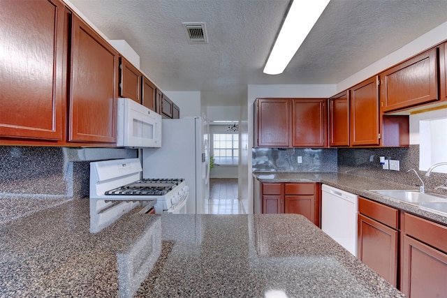 4026 Almond Lake Dr, Houston, TX 77047 - kitchen featuring white appliances, a sink, decorative backsplash, a textured ceiling, and brown cabinets