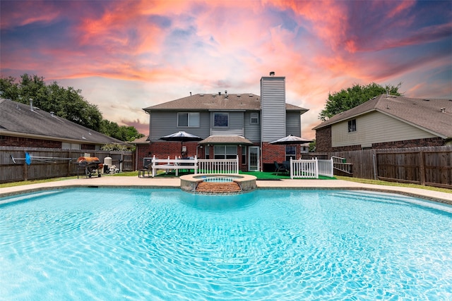 4026 Almond Lake Dr, Houston, TX 77047 - view of swimming pool with a fenced backyard, a pool with connected hot tub, and grilling area