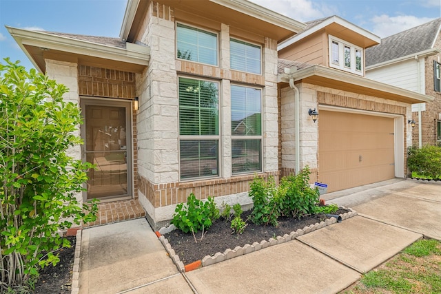 20210 Stonebridge Terrace Dr, Richmond, TX 77407 - doorway to property featuring an attached garage, driveway, and stone siding