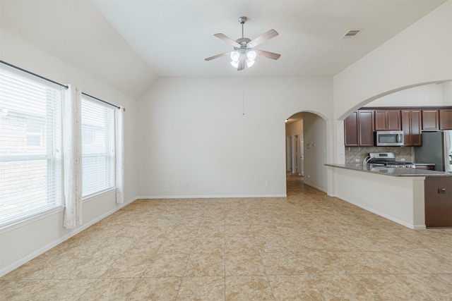 20210 Stonebridge Terrace Dr, Richmond, TX 77407 - unfurnished living room with lofted ceiling, arched walkways, ceiling fan, and light tile patterned floors