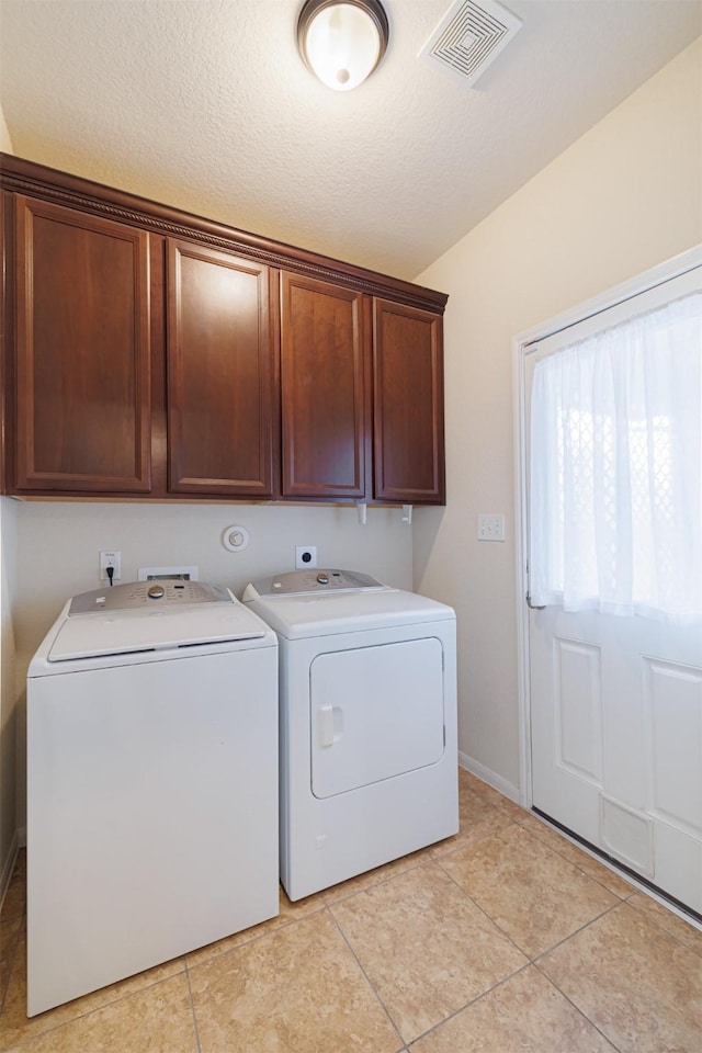 20210 Stonebridge Terrace Dr, Richmond, TX 77407 - laundry room featuring independent washer and dryer, cabinet space, light tile patterned floors, and baseboards
