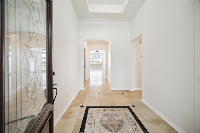 18519 Water Scene Trl, Cypress, TX 77429 - entrance foyer featuring arched walkways, light tile patterned floors, a high ceiling, crown molding, and baseboards