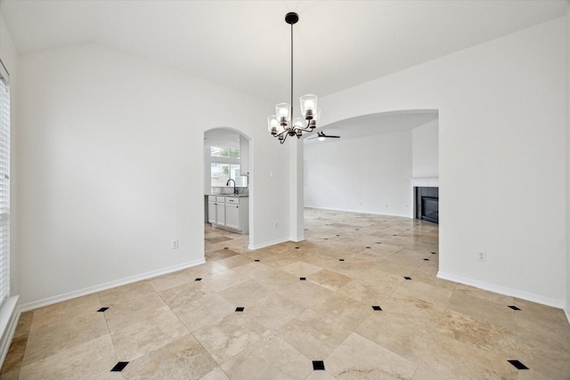 18519 Water Scene Trl, Cypress, TX 77429 - unfurnished dining area featuring arched walkways, a sink, a chandelier, a glass covered fireplace, and light tile patterned floors