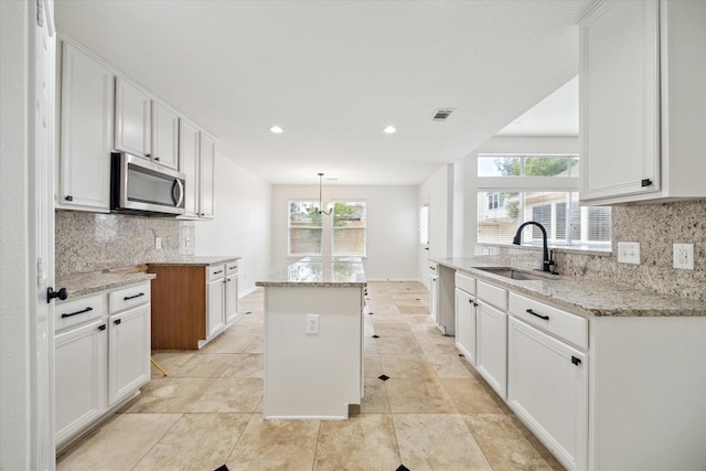 18519 Water Scene Trl, Cypress, TX 77429 - kitchen with stainless steel appliances, light stone counters, tasteful backsplash, white cabinetry, and recessed lighting