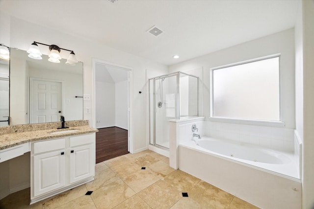 18519 Water Scene Trl, Cypress, TX 77429 - bathroom with vanity, a stall shower, a jetted tub, recessed lighting, and tile patterned floors