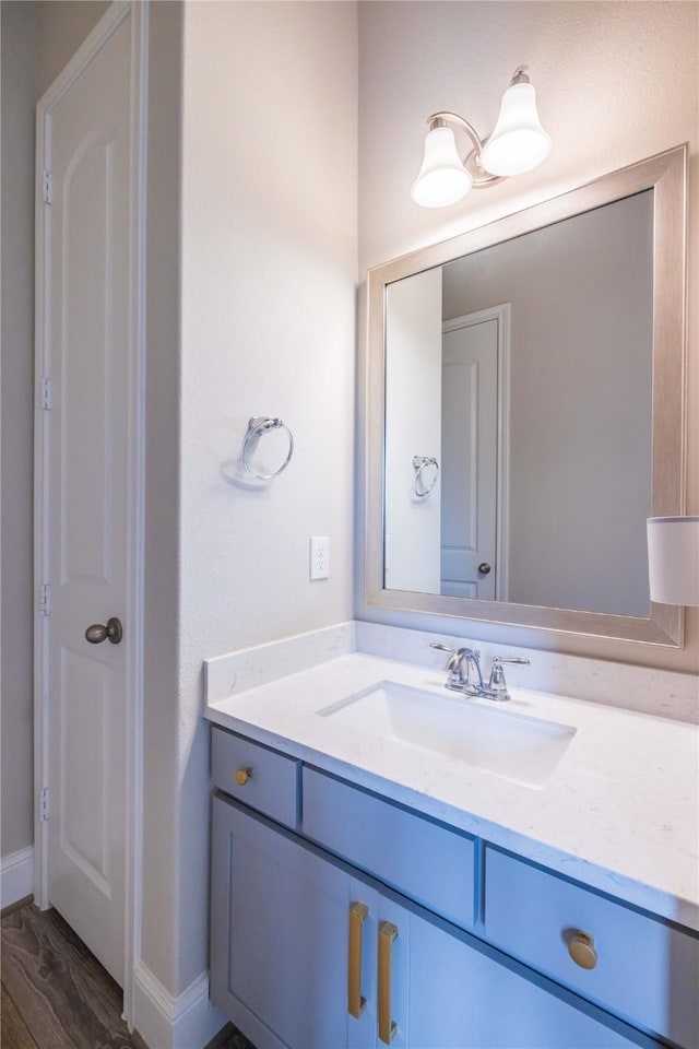 2002 Morton Cove Ct, Richmond, TX 77469 - bathroom with vanity, wood finished floors, and baseboards