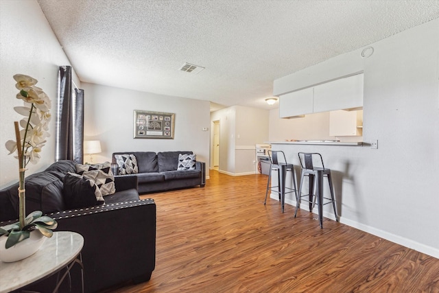 5707 Cripple Brook Ct, Houston, TX 77017 - living room featuring wood finished floors, a textured ceiling, and baseboards