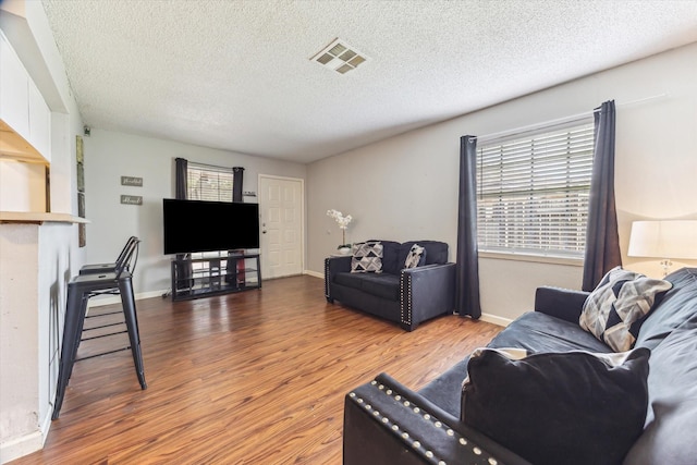 5707 Cripple Brook Ct, Houston, TX 77017 - living room featuring wood finished floors, a textured ceiling, and baseboards