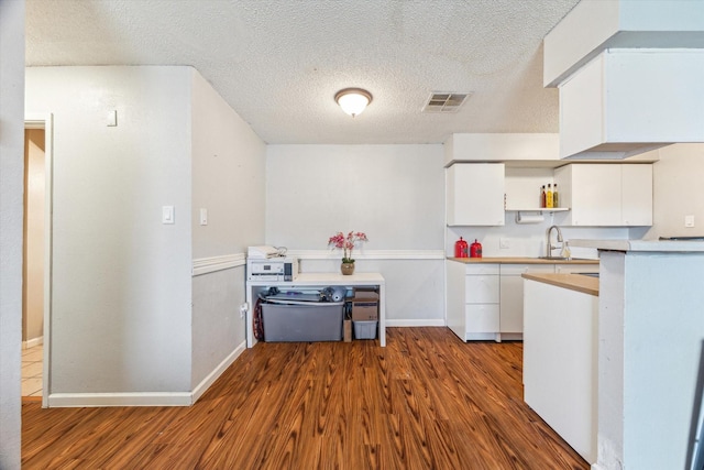 5707 Cripple Brook Ct, Houston, TX 77017 - kitchen featuring dark wood-type flooring, white cabinets, open shelves, a sink, and baseboards