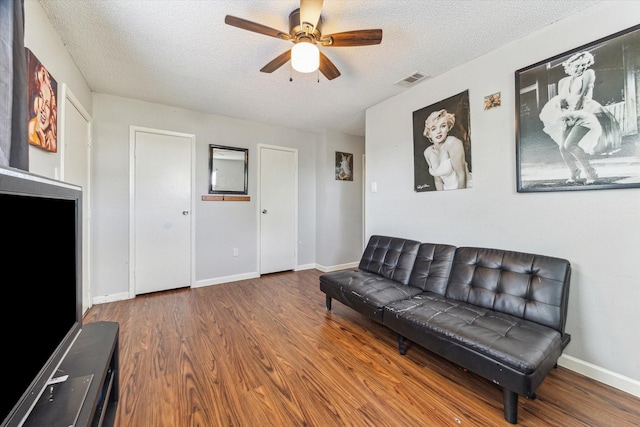 5707 Cripple Brook Ct, Houston, TX 77017 - living area featuring ceiling fan, a textured ceiling, wood finished floors, and baseboards