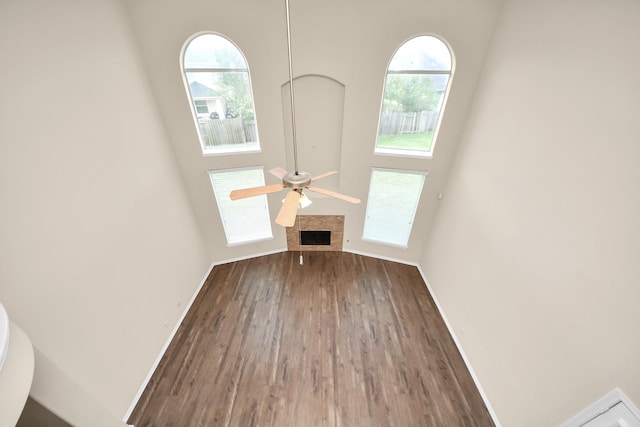 2304 Shadow Canyon Ct, Pearland, TX 77584 - unfurnished living room featuring plenty of natural light, wood finished floors, a ceiling fan, and baseboards