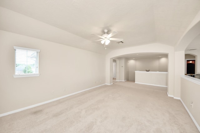 2304 Shadow Canyon Ct, Pearland, TX 77584 - spare room with arched walkways, ceiling fan, light carpet, baseboards, and lofted ceiling
