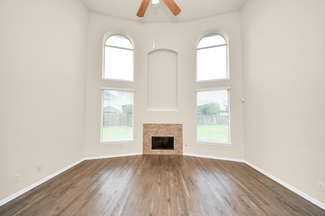 2304 Shadow Canyon Ct, Pearland, TX 77584 - unfurnished living room with plenty of natural light, ceiling fan, dark wood finished floors, baseboards, and a high ceiling