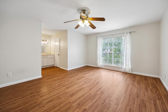 14333 Memorial Dr Unit 72, Houston, TX 77079 - spare room featuring wood finished floors, baseboards, and a ceiling fan