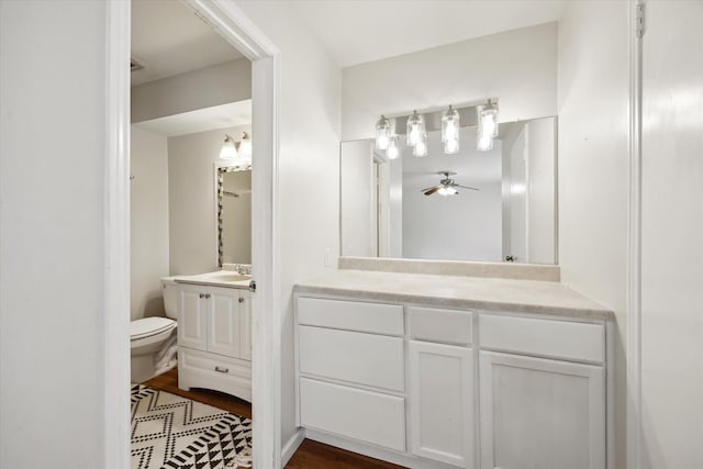 14333 Memorial Dr Unit 72, Houston, TX 77079 - bathroom featuring vanity, ceiling fan, wood finished floors, and toilet