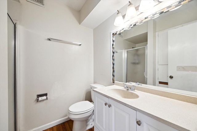 14333 Memorial Dr Unit 72, Houston, TX 77079 - bathroom featuring a stall shower, vanity, toilet, wood finished floors, and baseboards