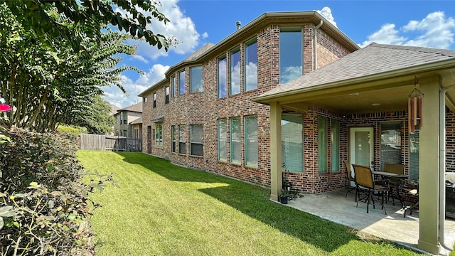 19406 Egret Haven Ln, Cypress, TX 77433 - back of property featuring brick siding and a patio