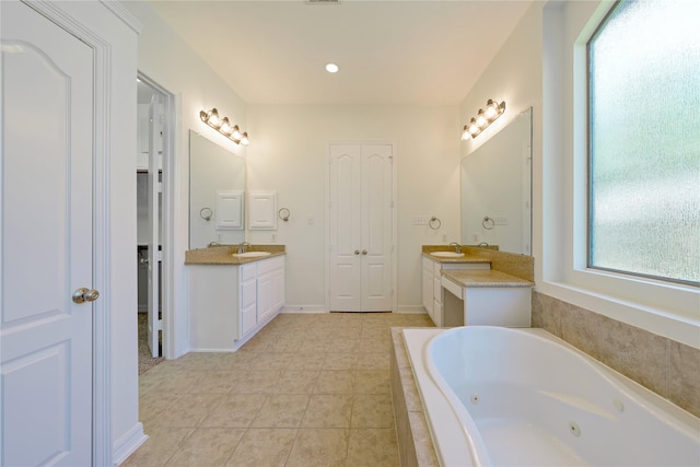 19406 Egret Haven Ln, Cypress, TX 77433 - full bath with two vanities, a jetted tub, and tile patterned flooring