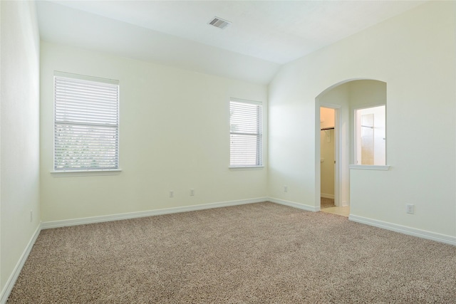 19406 Egret Haven Ln, Cypress, TX 77433 - unfurnished room featuring arched walkways, light colored carpet, baseboards, and lofted ceiling