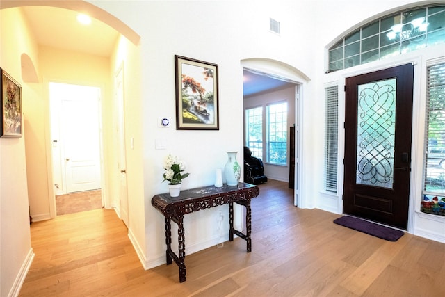 19406 Egret Haven Ln, Cypress, TX 77433 - entryway featuring light wood-type flooring, arched walkways, and baseboards