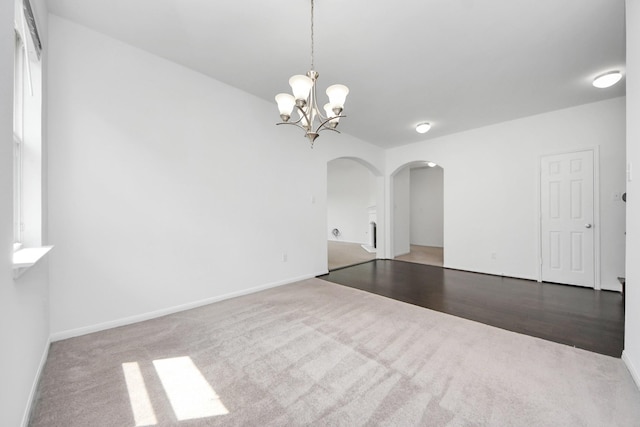 3727 Varna Ct, Missouri City, TX 77459 - spare room with arched walkways, carpet floors, a chandelier, and baseboards