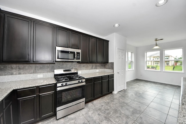 3727 Varna Ct, Missouri City, TX 77459 - kitchen with stainless steel appliances, backsplash, light stone countertops, baseboards, and recessed lighting