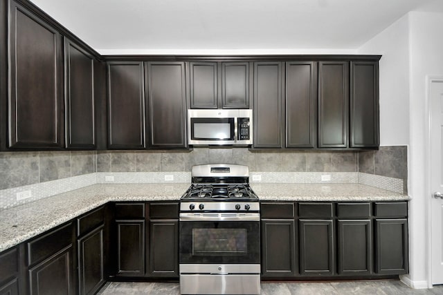 3727 Varna Ct, Missouri City, TX 77459 - kitchen with stainless steel appliances, light stone countertops, and dark brown cabinets