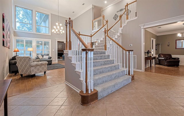 1806 Wine Cedar Ln, Katy, TX 77450 - stairway featuring crown molding, a chandelier, tile patterned flooring, a high ceiling, and baseboards