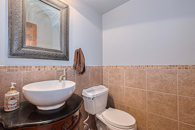 1806 Wine Cedar Ln, Katy, TX 77450 - half bath with tile walls, a wainscoted wall, toilet, and vanity