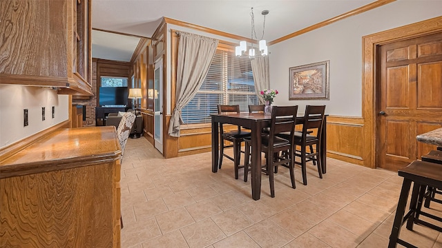 1806 Wine Cedar Ln, Katy, TX 77450 - dining space featuring a chandelier, crown molding, a wainscoted wall, a brick fireplace, and wood walls
