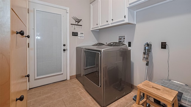 1806 Wine Cedar Ln, Katy, TX 77450 - laundry room with cabinet space, independent washer and dryer, and light tile patterned floors
