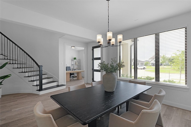 4706 Oak Glen Ct, Manvel, TX 77578 - dining room with a chandelier, wood finished floors, baseboards, and stairs