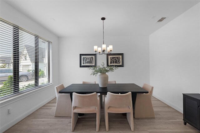 4706 Oak Glen Ct, Manvel, TX 77578 - dining space with a chandelier, baseboards, and light wood-type flooring