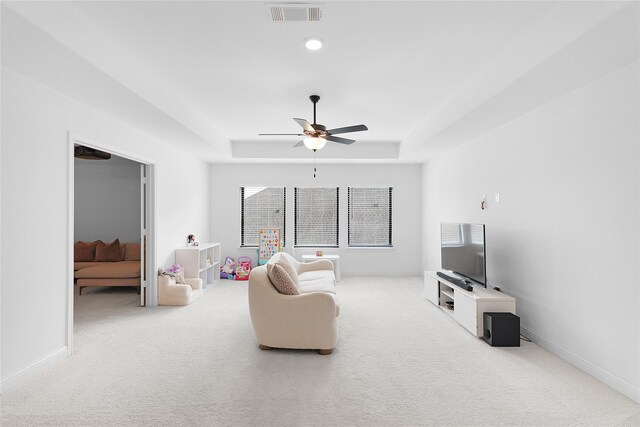 4706 Oak Glen Ct, Manvel, TX 77578 - carpeted living room featuring a tray ceiling, ceiling fan, and baseboards