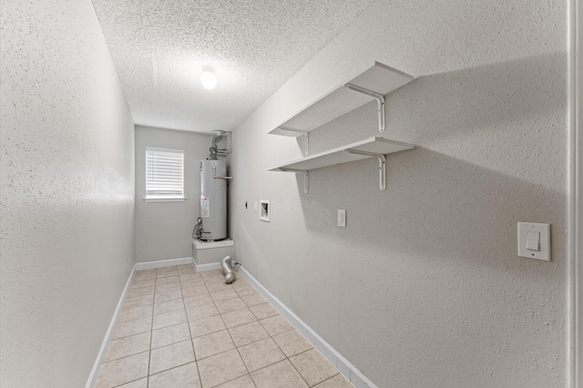 4519 Pioneer Trl, Sugar Land, TX 77479 - laundry area featuring water heater, light tile patterned floors, hookup for a washing machine, baseboards, and a textured ceiling