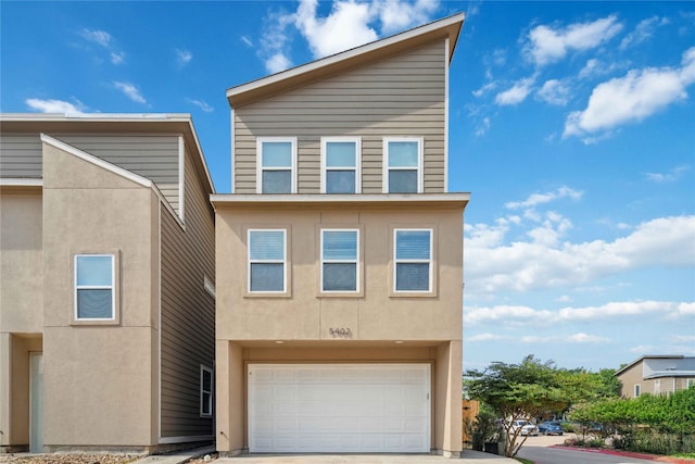5402 Jonathan Ln, Houston, TX 77011 - view of property with stucco siding, concrete driveway, and a garage