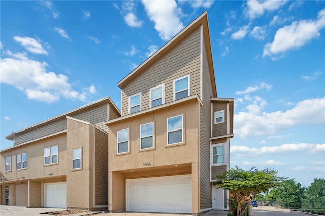 5402 Jonathan Ln, Houston, TX 77011 - view of property featuring an attached garage, concrete driveway, and stucco siding
