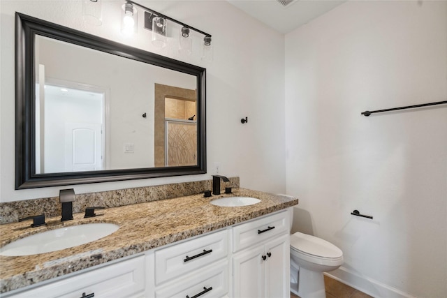 5402 Jonathan Ln, Houston, TX 77011 - full bath with toilet, double vanity, tile patterned floors, a shower with shower door, and baseboards