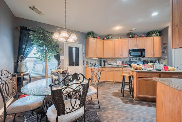 16702 Morning Shadows Way, Humble, TX 77346 - kitchen featuring black microwave, light brown cabinets, a chandelier, electric range, and wood finish floors