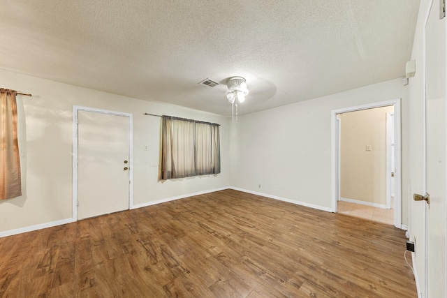 7306 Nightingale Cir, Texas City, TX 77591 - unfurnished room featuring ceiling fan, wood finished floors, a textured ceiling, and baseboards