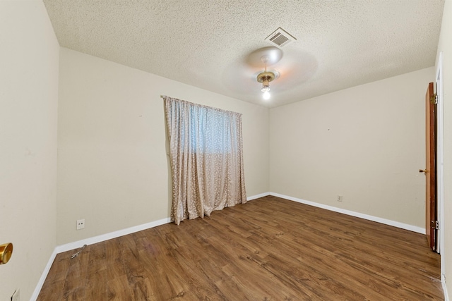 7306 Nightingale Cir, Texas City, TX 77591 - spare room featuring wood finished floors, a textured ceiling, and baseboards
