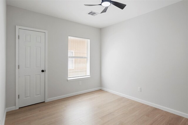 2811 Winbern St, Houston, TX 77004 - spare room with a ceiling fan, light wood-style floors, and baseboards