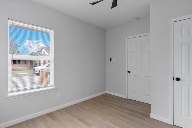 2811 Winbern St, Houston, TX 77004 - unfurnished bedroom with light wood-style flooring, baseboards, and multiple windows