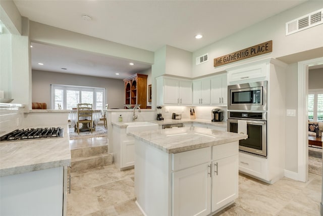 14001/14009 W Hughes Rd, Dickinson, TX 77539 - kitchen featuring stainless steel appliances, a sink, decorative backsplash, white cabinetry, and recessed lighting
