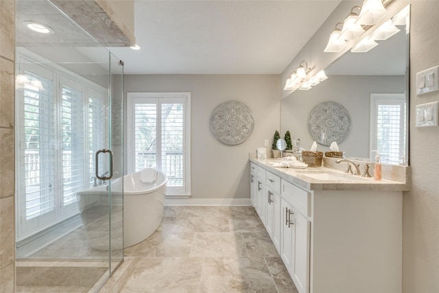 14001/14009 W Hughes Rd, Dickinson, TX 77539 - full bath with a freestanding bath, double vanity, a shower stall, and baseboards