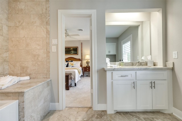 14001/14009 W Hughes Rd, Dickinson, TX 77539 - bathroom featuring connected bathroom, vanity, ceiling fan, a tub, and baseboards