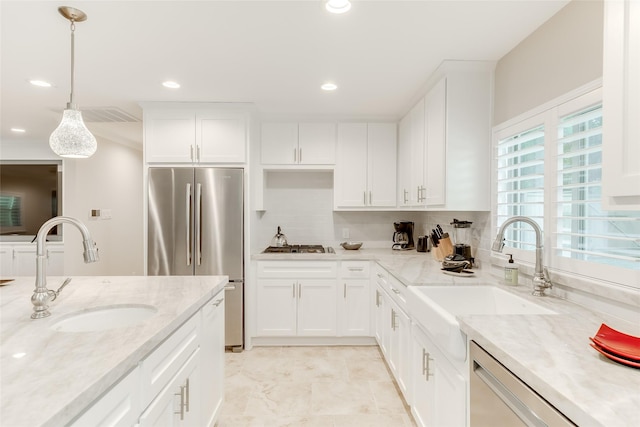 14001/14009 W Hughes Rd, Dickinson, TX 77539 - kitchen with appliances with stainless steel finishes, a sink, decorative backsplash, white cabinetry, and recessed lighting