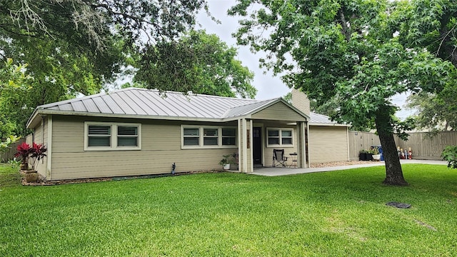 14001/14009 W Hughes Rd, Dickinson, TX 77539 - ranch-style house with a patio, metal roof, and a chimney